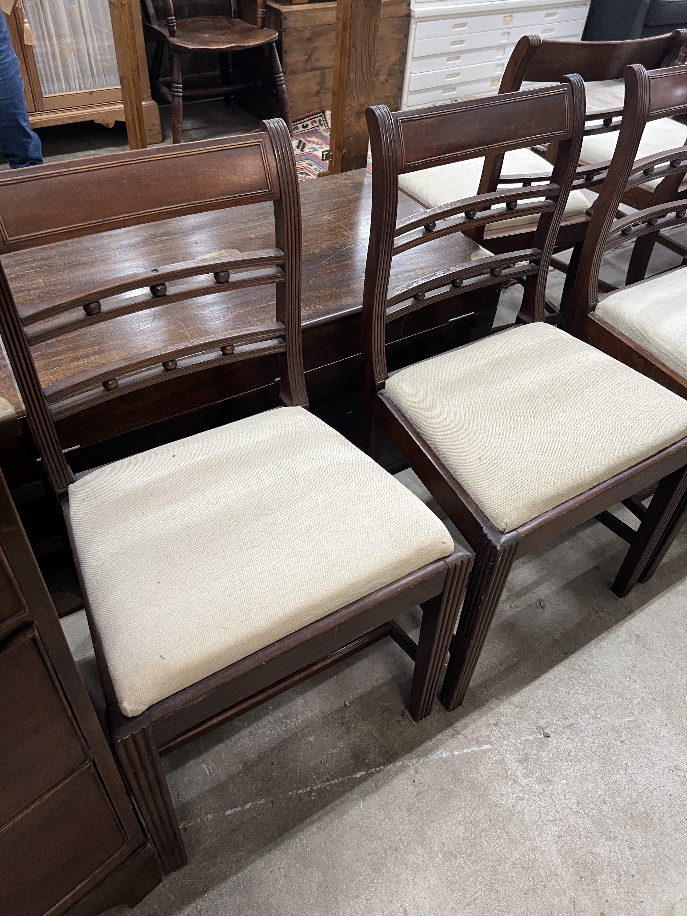 A set of six George III provincial mahogany dining chairs, one with arms